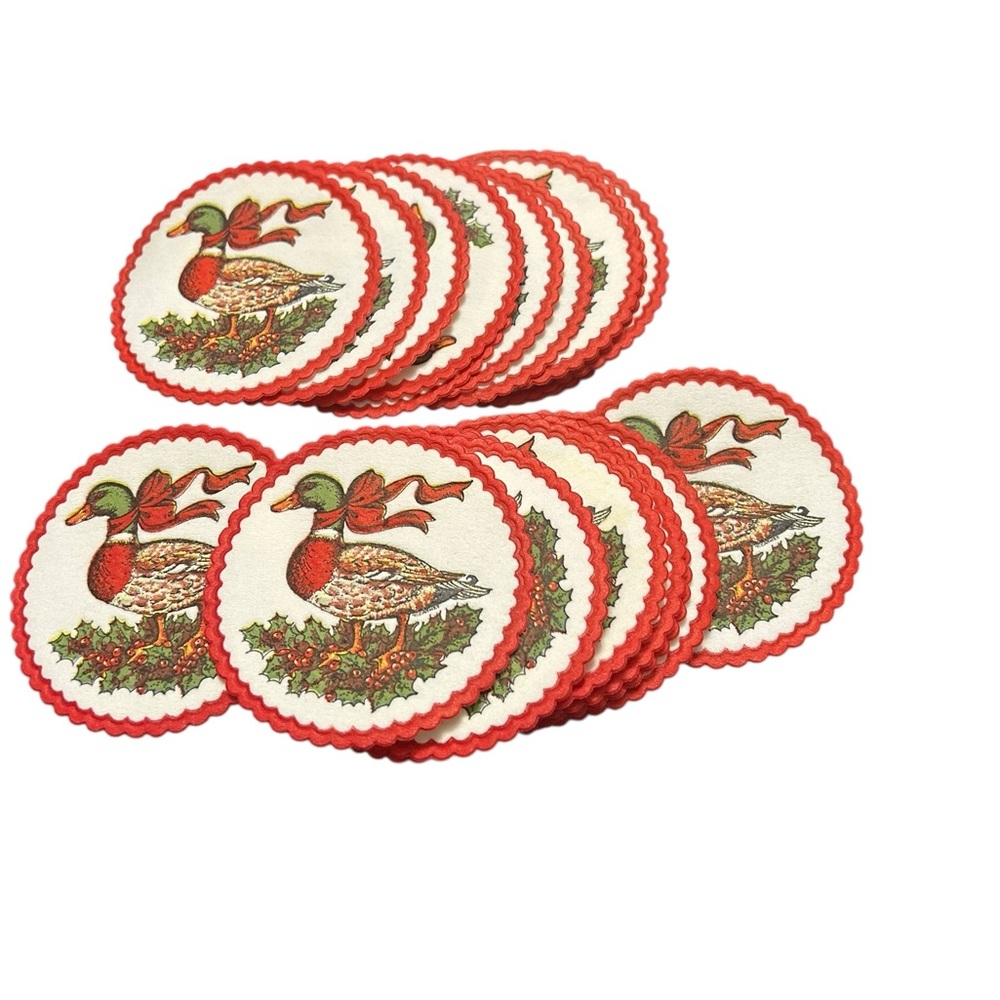vintage 80s Christmas paper coasters featuring a duck with a red bow and holly.